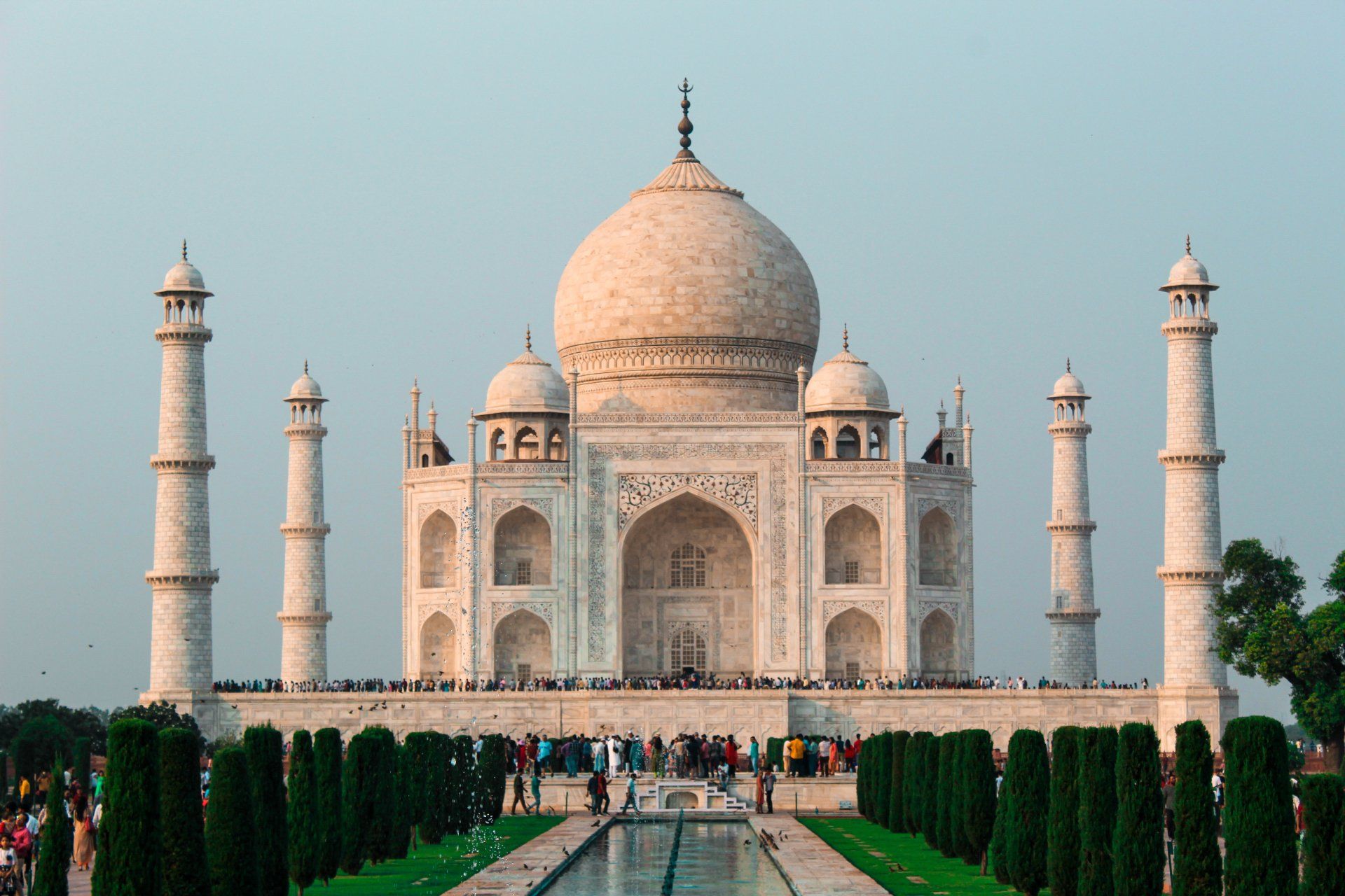 Taj Mahal, Agra, India: White marble mausoleum with dome, minarets, and reflecting pool.
