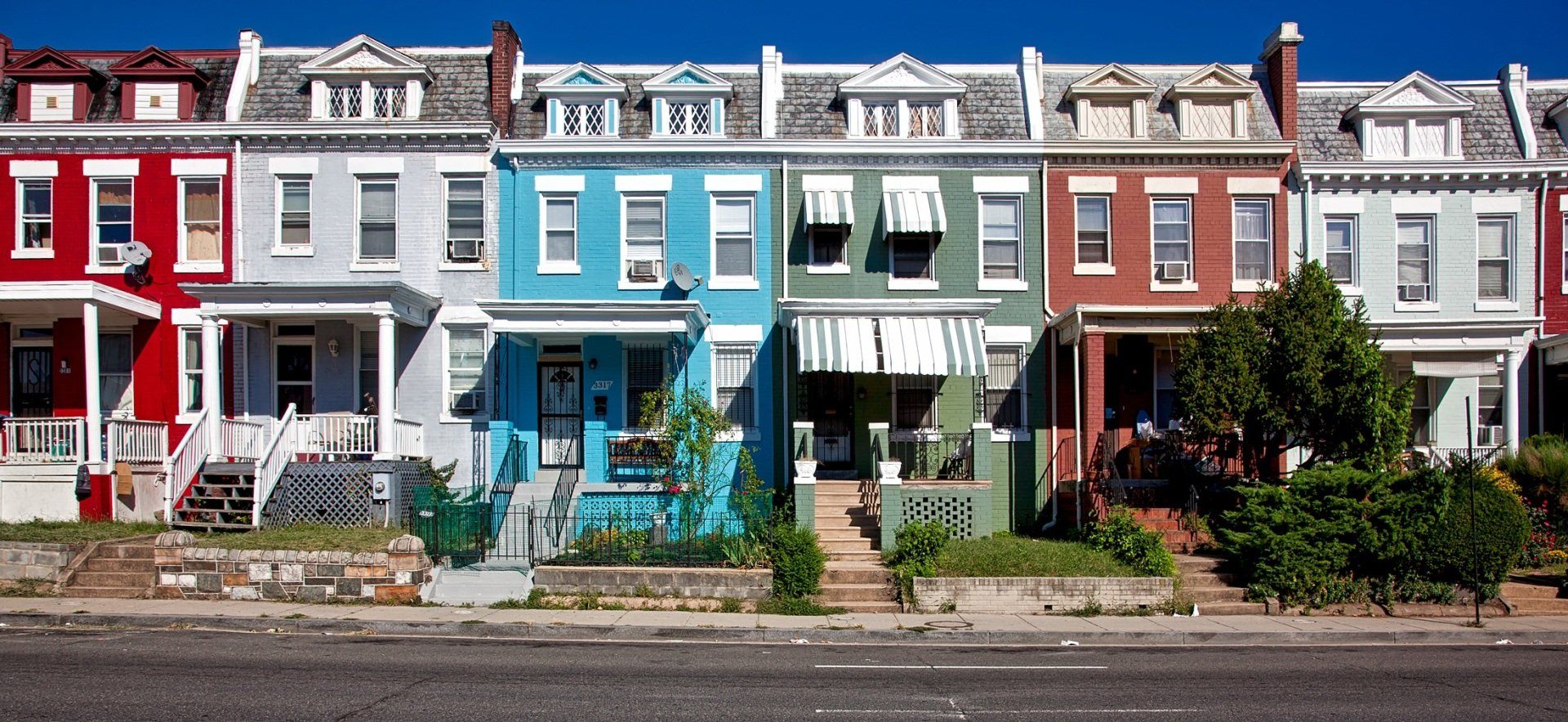 a row of colorful houses on a sunny day
