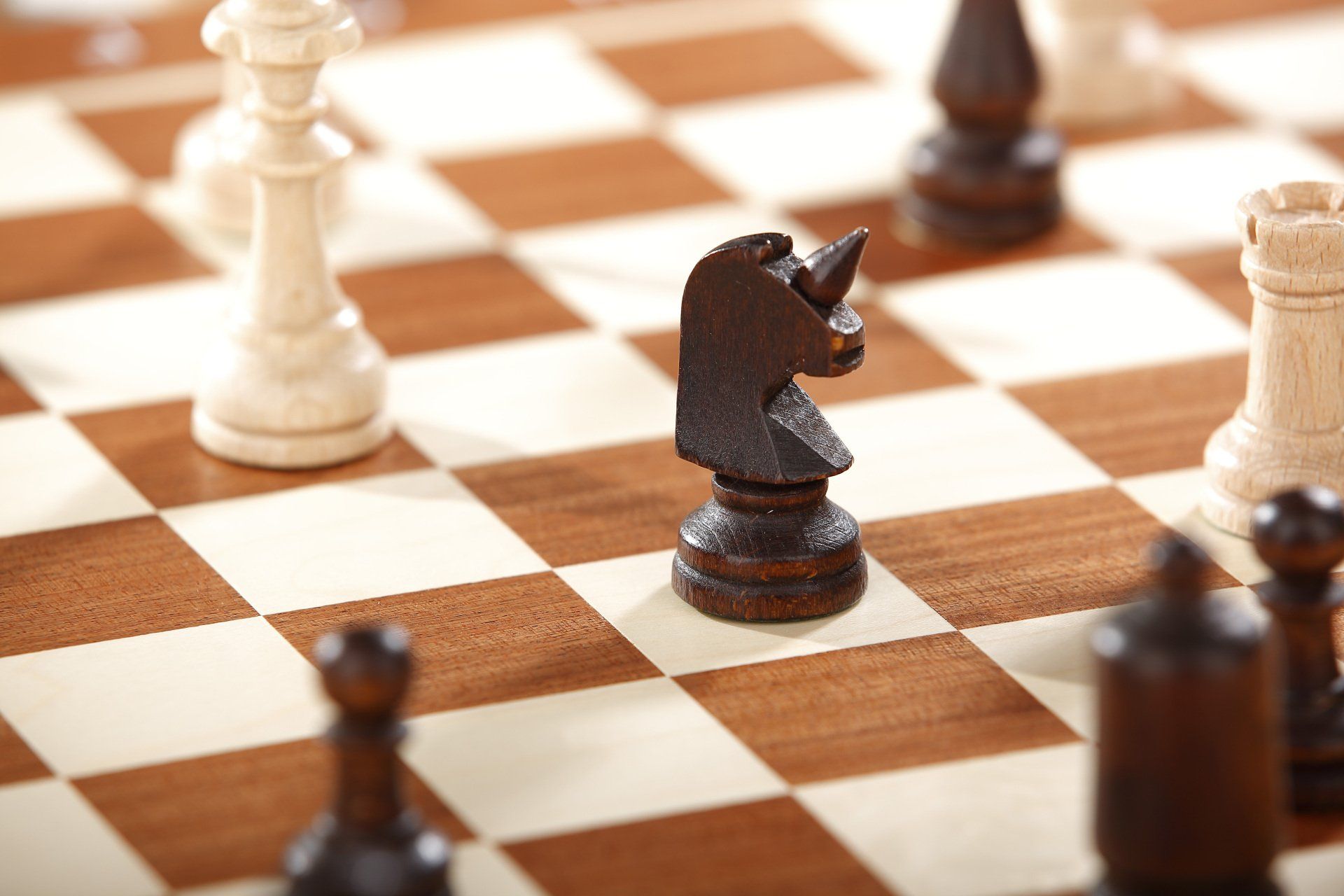 A close up of a chess board with pieces on it