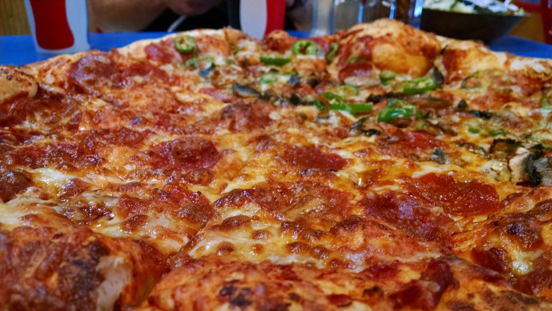 A close up of a pizza with pepperoni and cheese on a table.