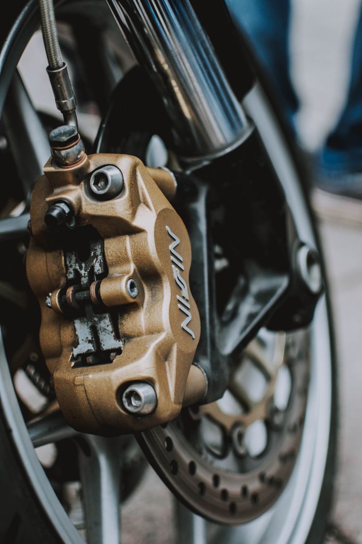 A close up of a nigin brake caliper on a motorcycle