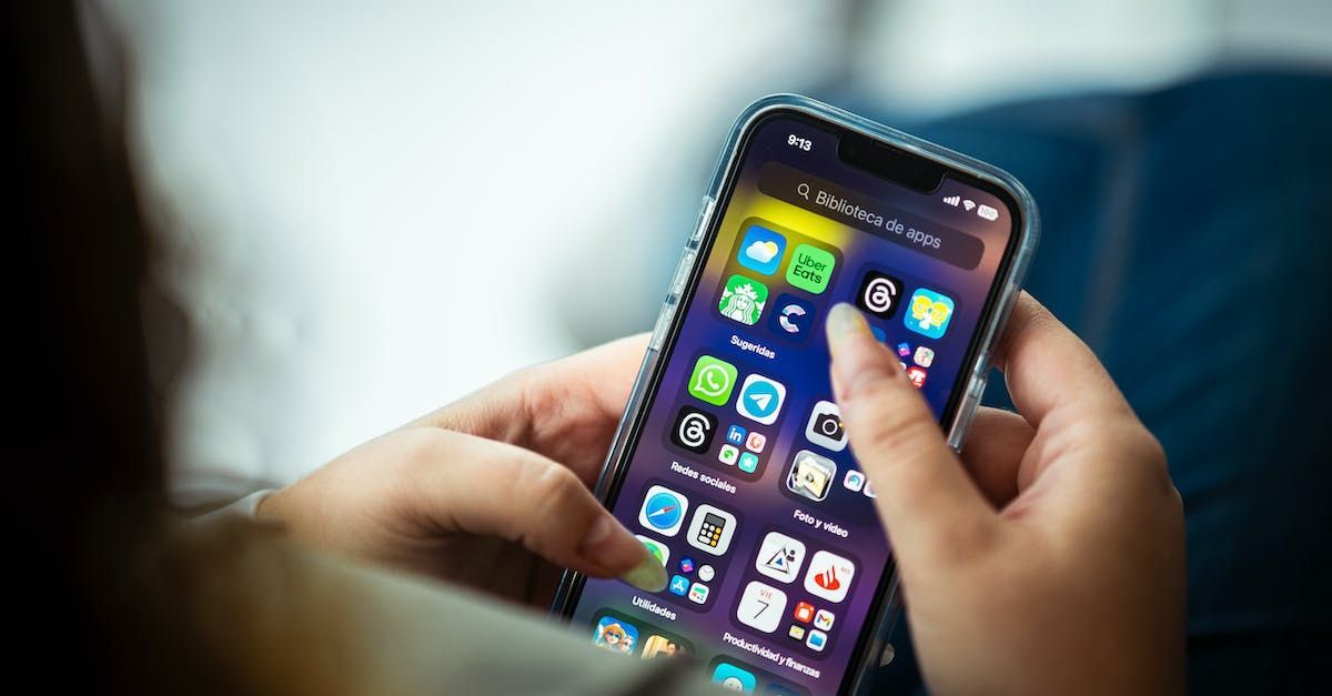 A person is holding a cell phone in their hands.