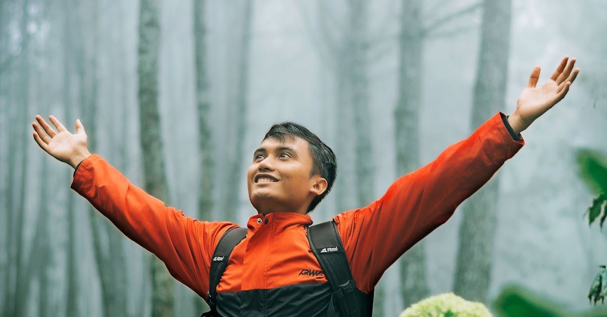 Man with outstretched arms, free from neck pain.