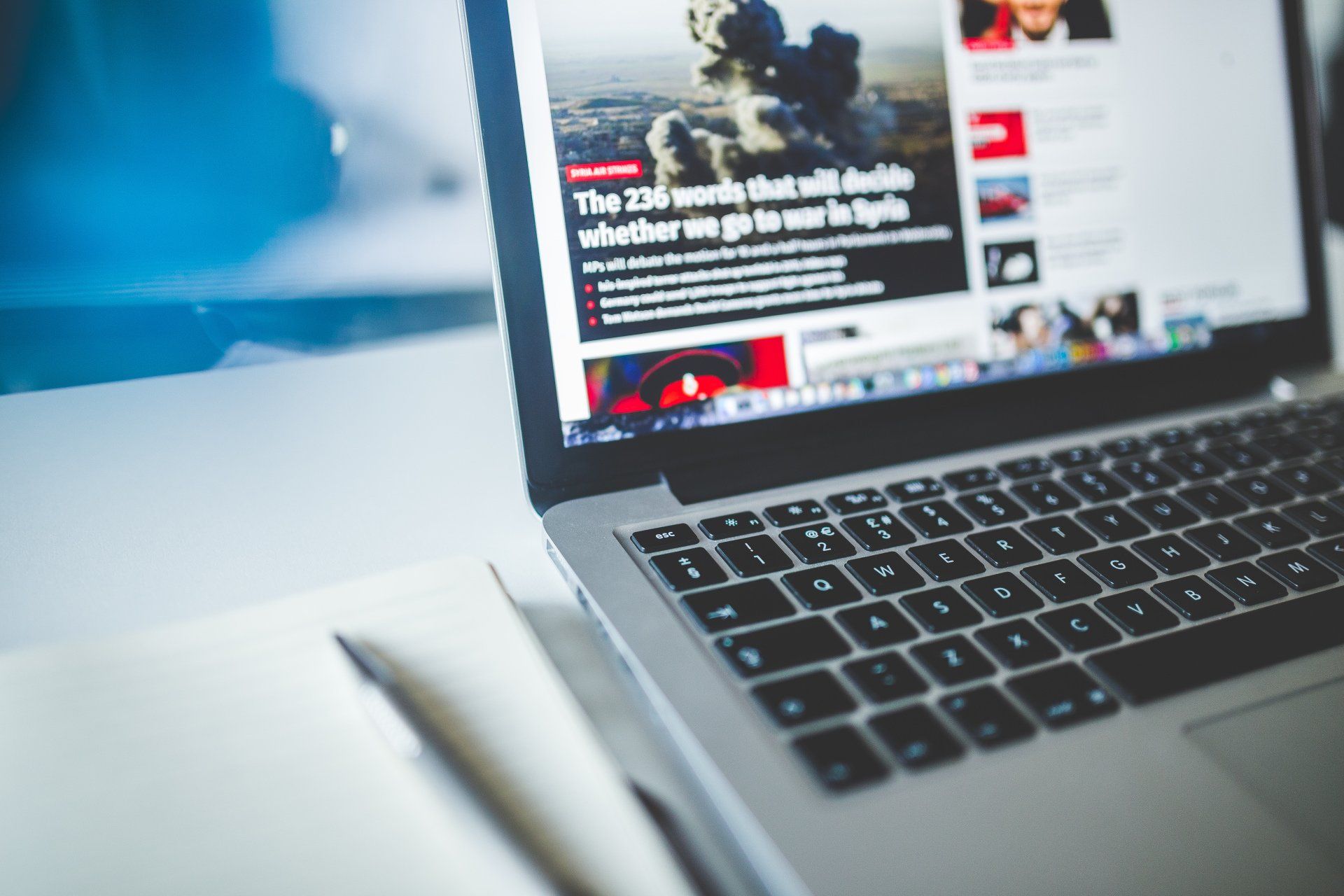 A laptop computer is open to a news website.