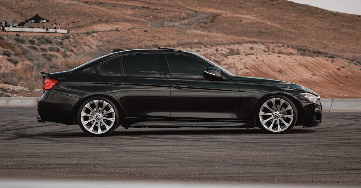 A black car is parked on the side of the road.