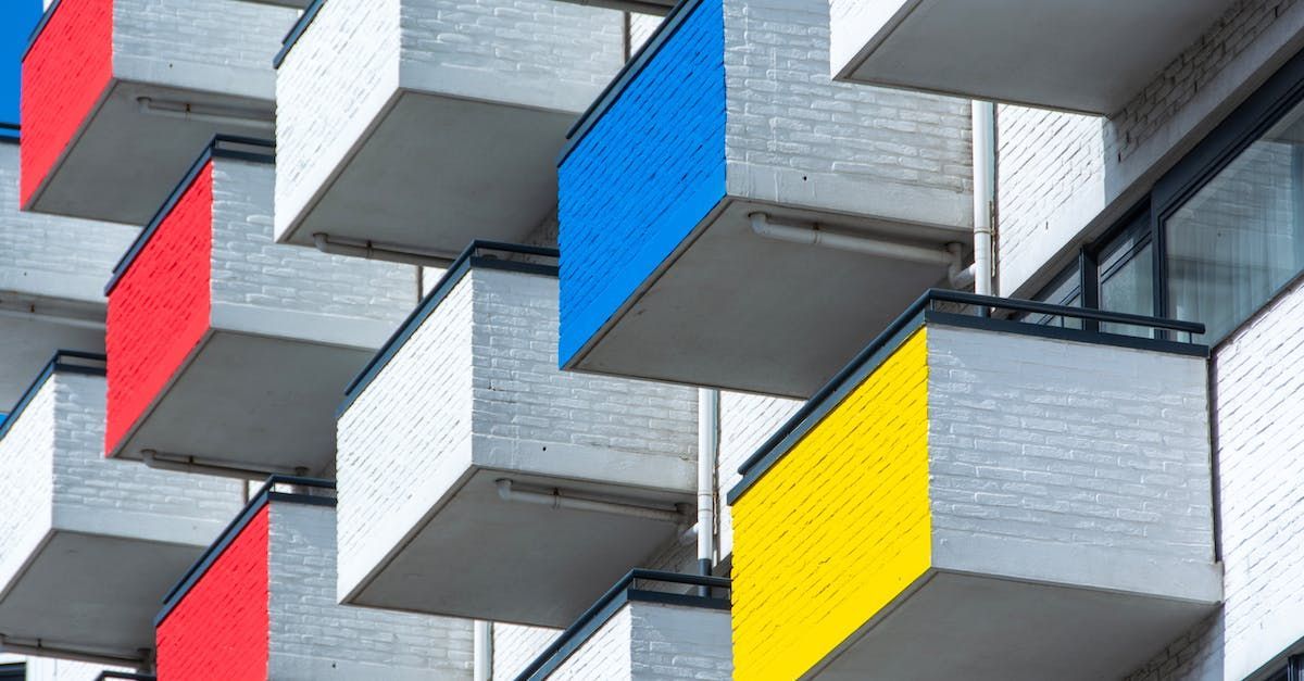 A building with a lot of balconies painted in different colors.