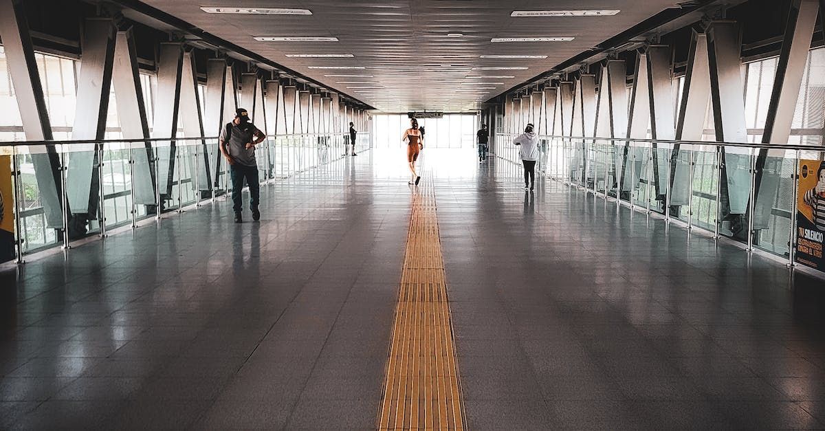 A group of people are walking across a bridge.