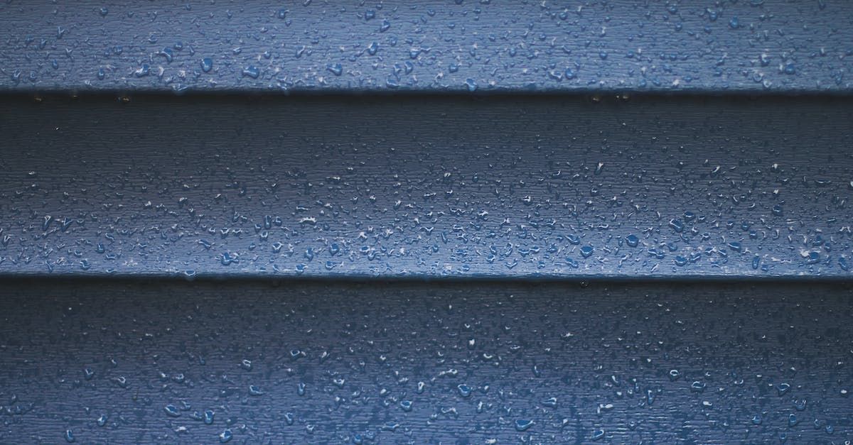 A close up of a blue siding on a house.
