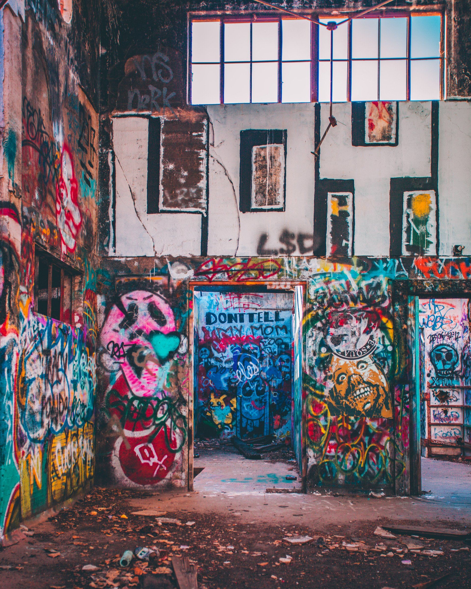 A room with a lot of graffiti on the walls including the letters lsf
