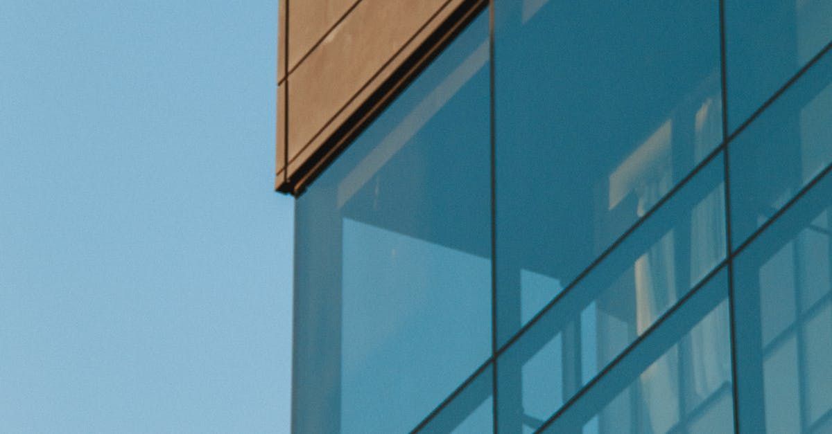 A close up of a building with a lot of windows against a blue sky.