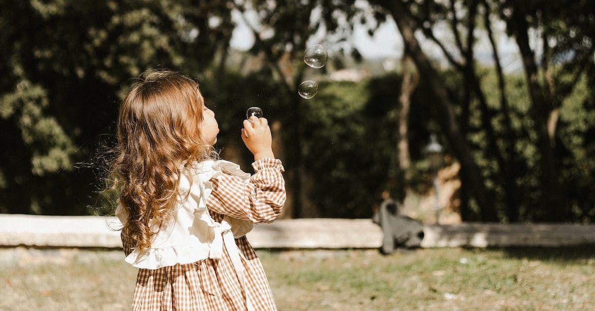 A girl is standing upright in a certain position.