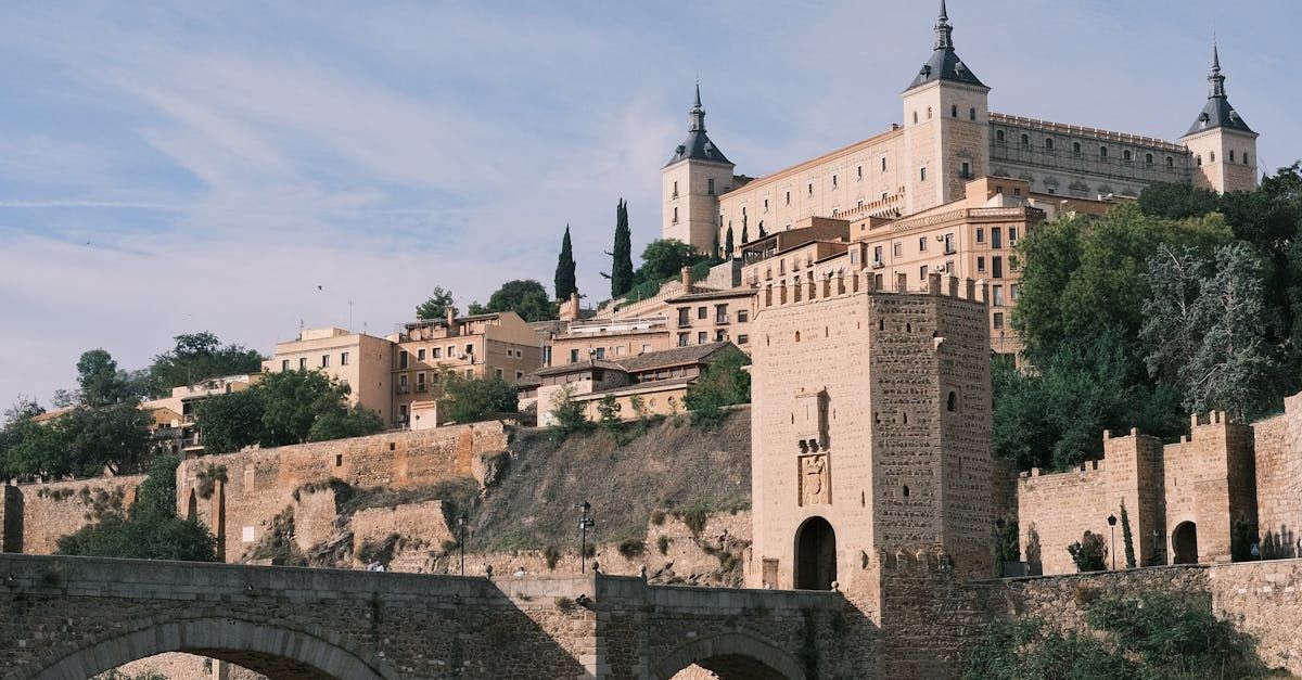 A bridge over a river with a castle in the background