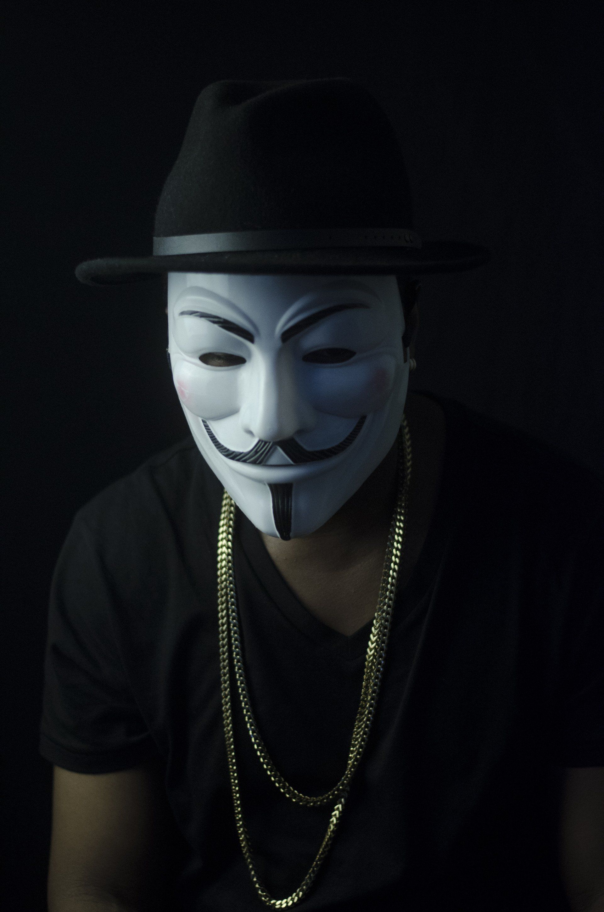 A man wearing a hat and a mask with a mustache