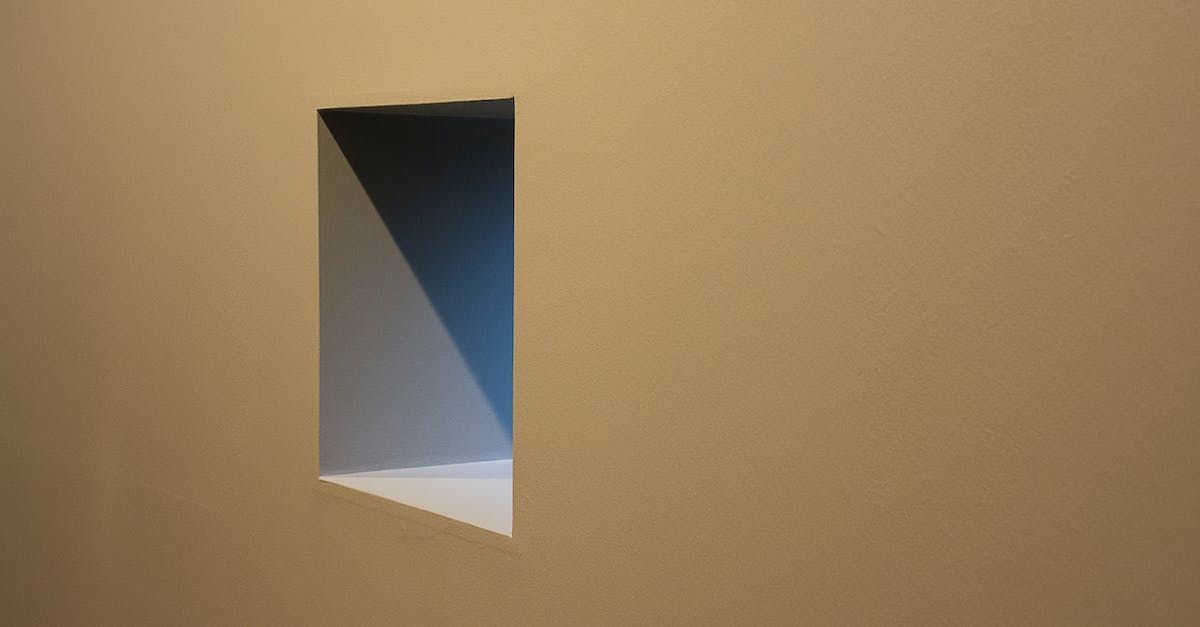 an egress window in a basement wall with  light coming out of it