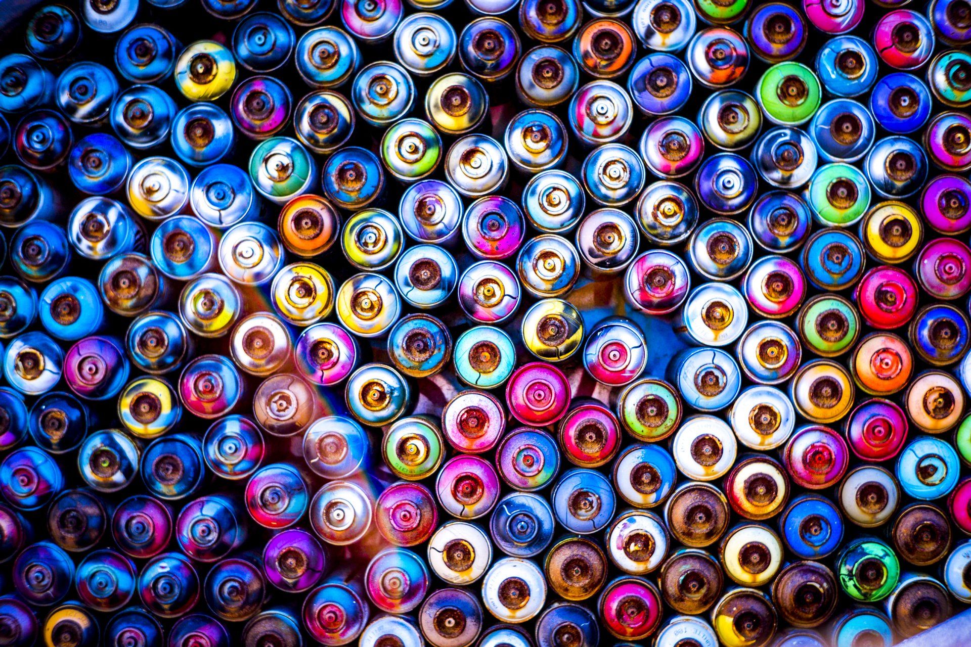 Collection of colorful spray paint cans. Guide to wood spray paint selection and application for home projects.