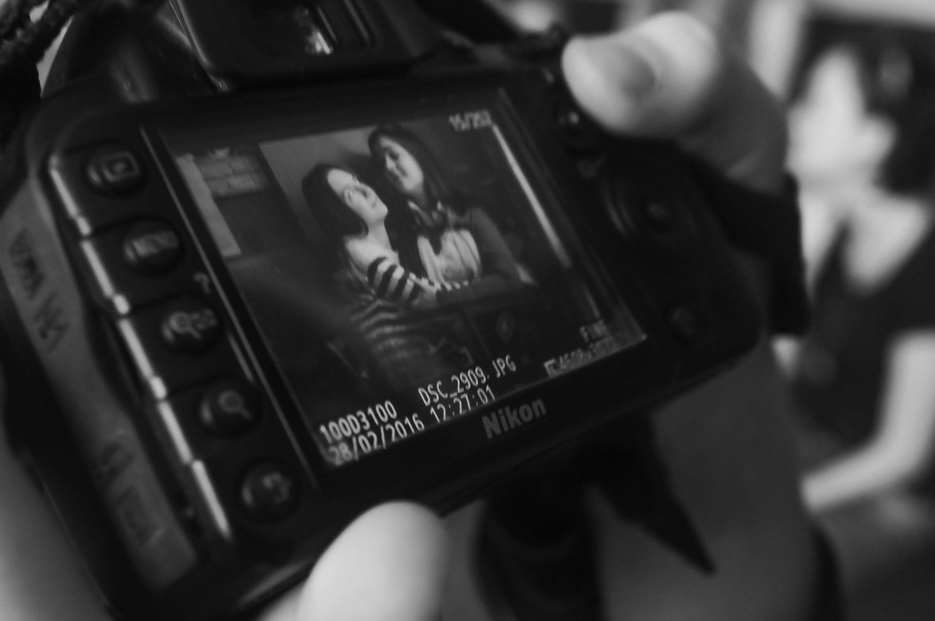 A person is taking a picture with a nikon camera