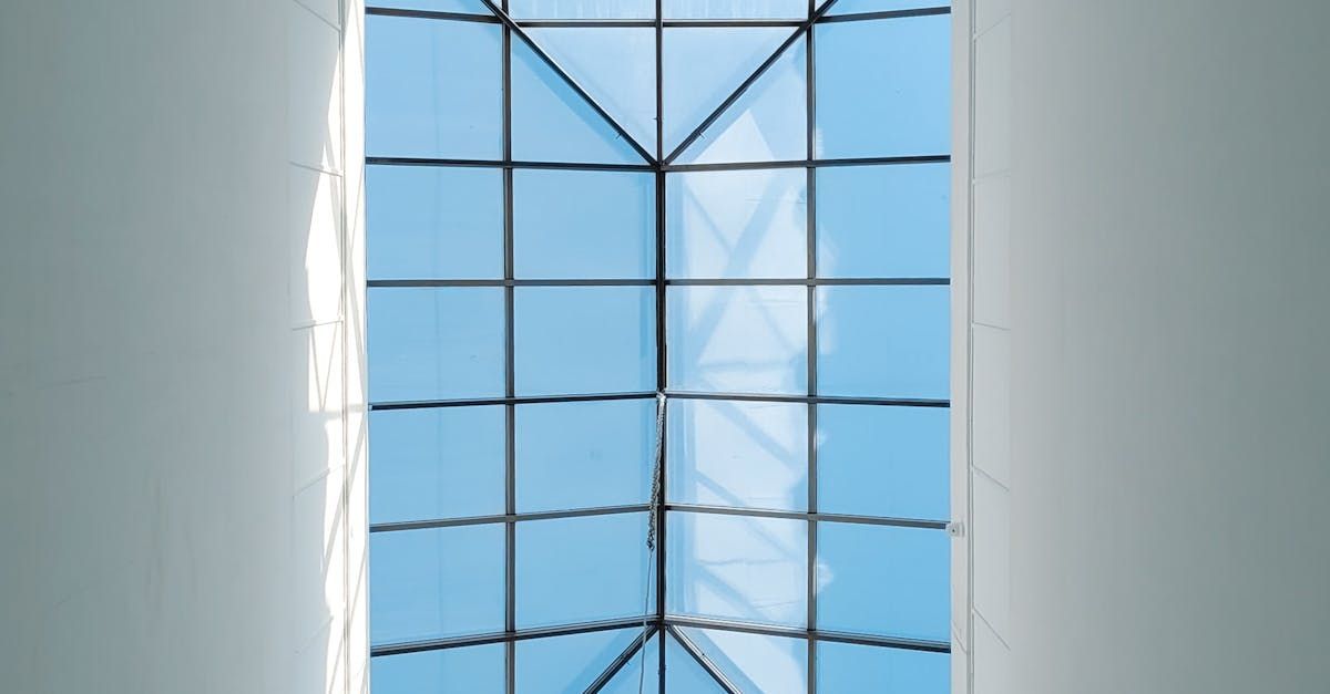 a window with a glass roof and a blue sky behind it