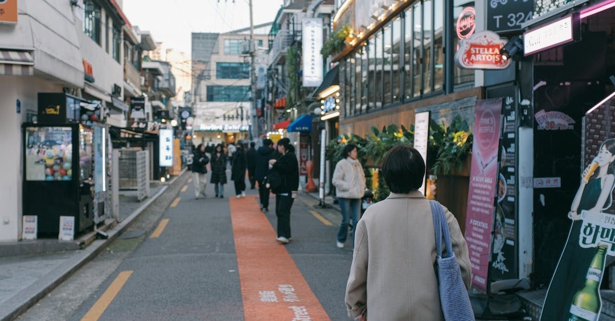 A woman is walking down a busy city street.