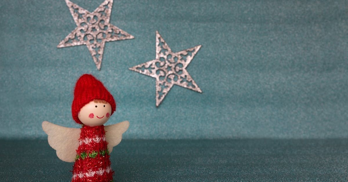 a christmas angel with a red hat and white wings
