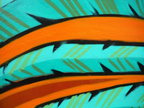 Orange, spiky lines on turquoise background with darker green accents.