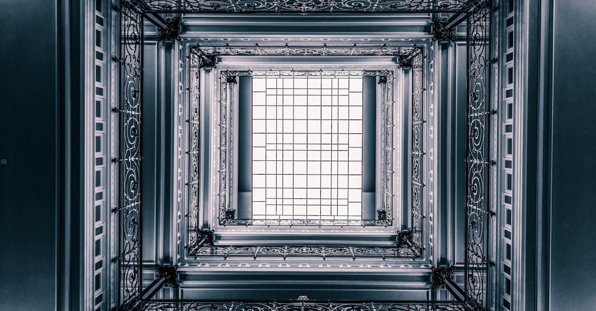 Looking up through an ornate historic stairwell or atrium with a large skylight