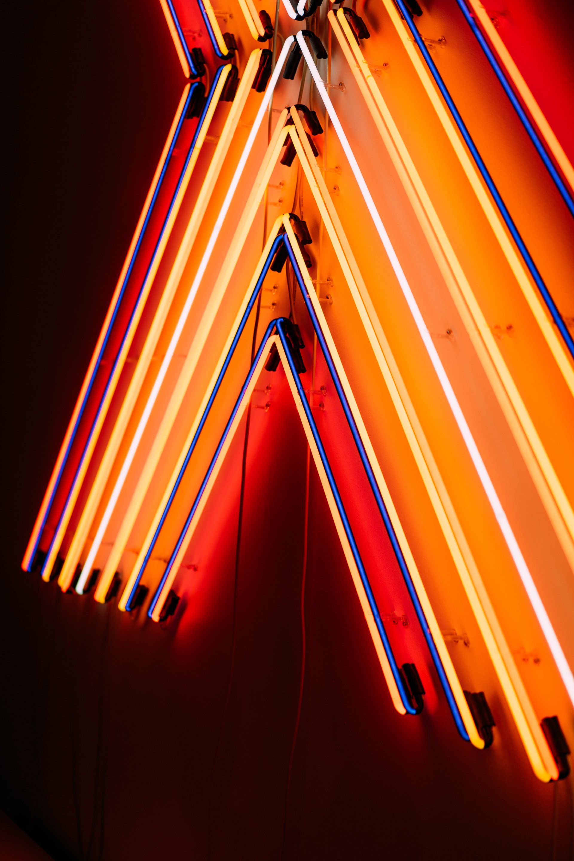 A neon triangle light in orange