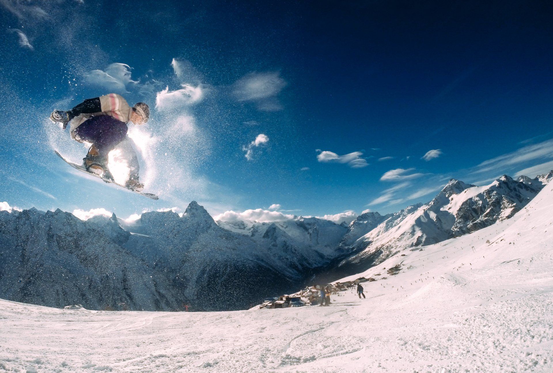 A snowboarder is doing a trick in the air