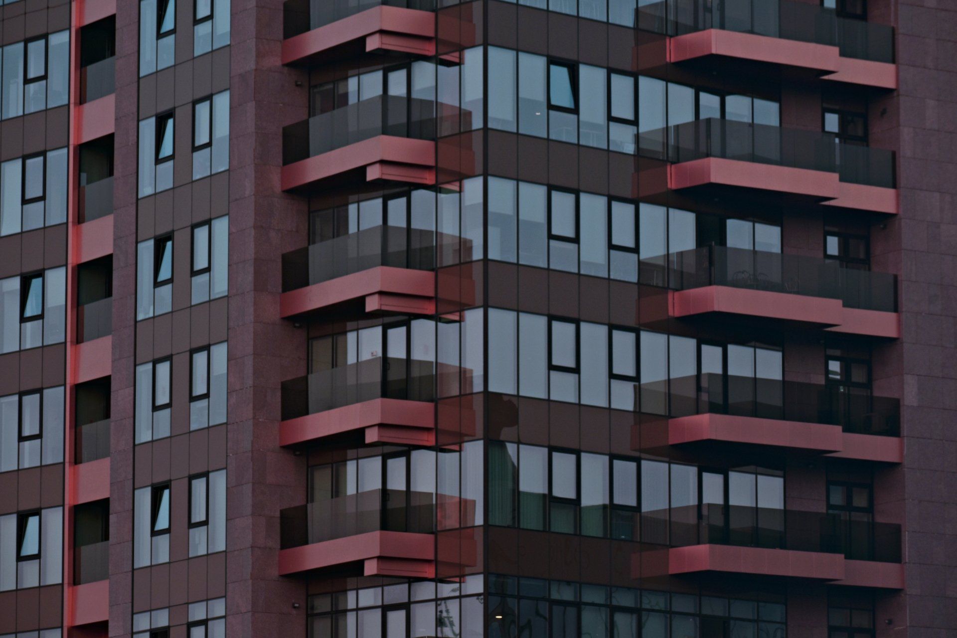 A tall building with a lot of windows and balconies.