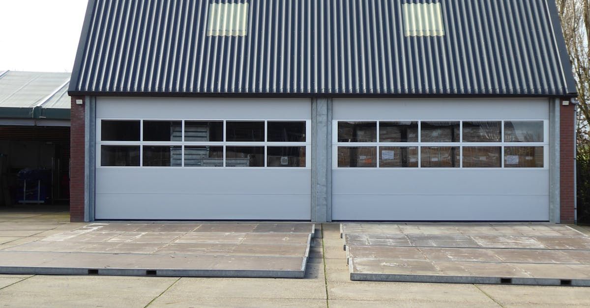 There are two garage doors in front of a house.