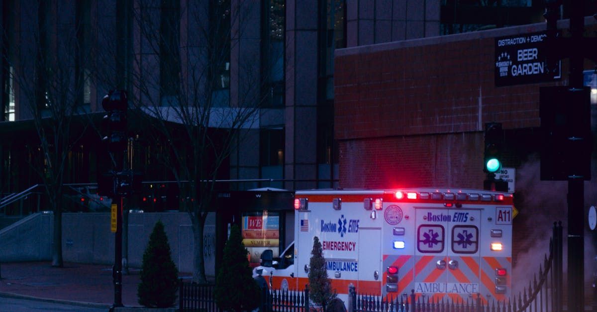 photo of an ambulance with emergency flashers on a dark night