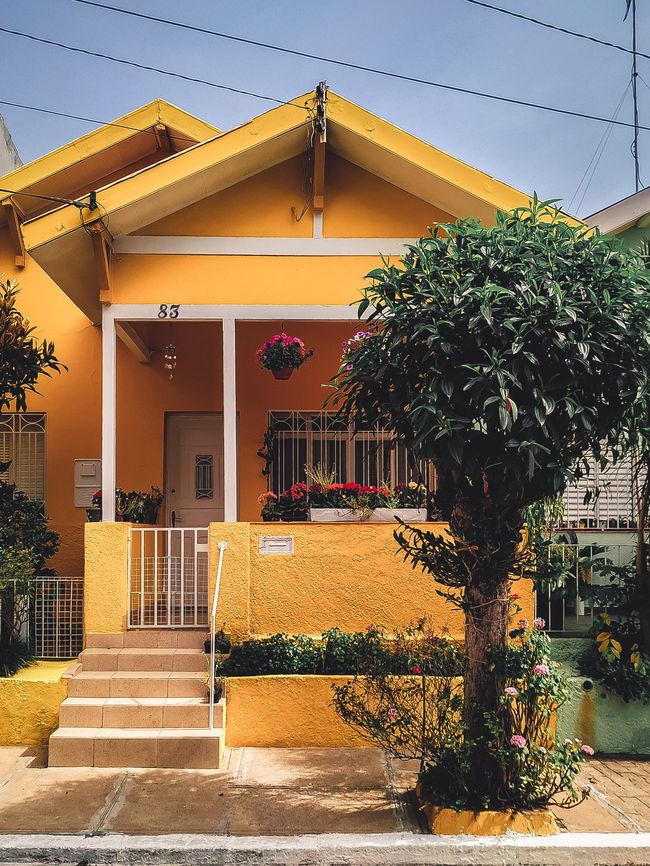 A yellow house with the number 47 on it