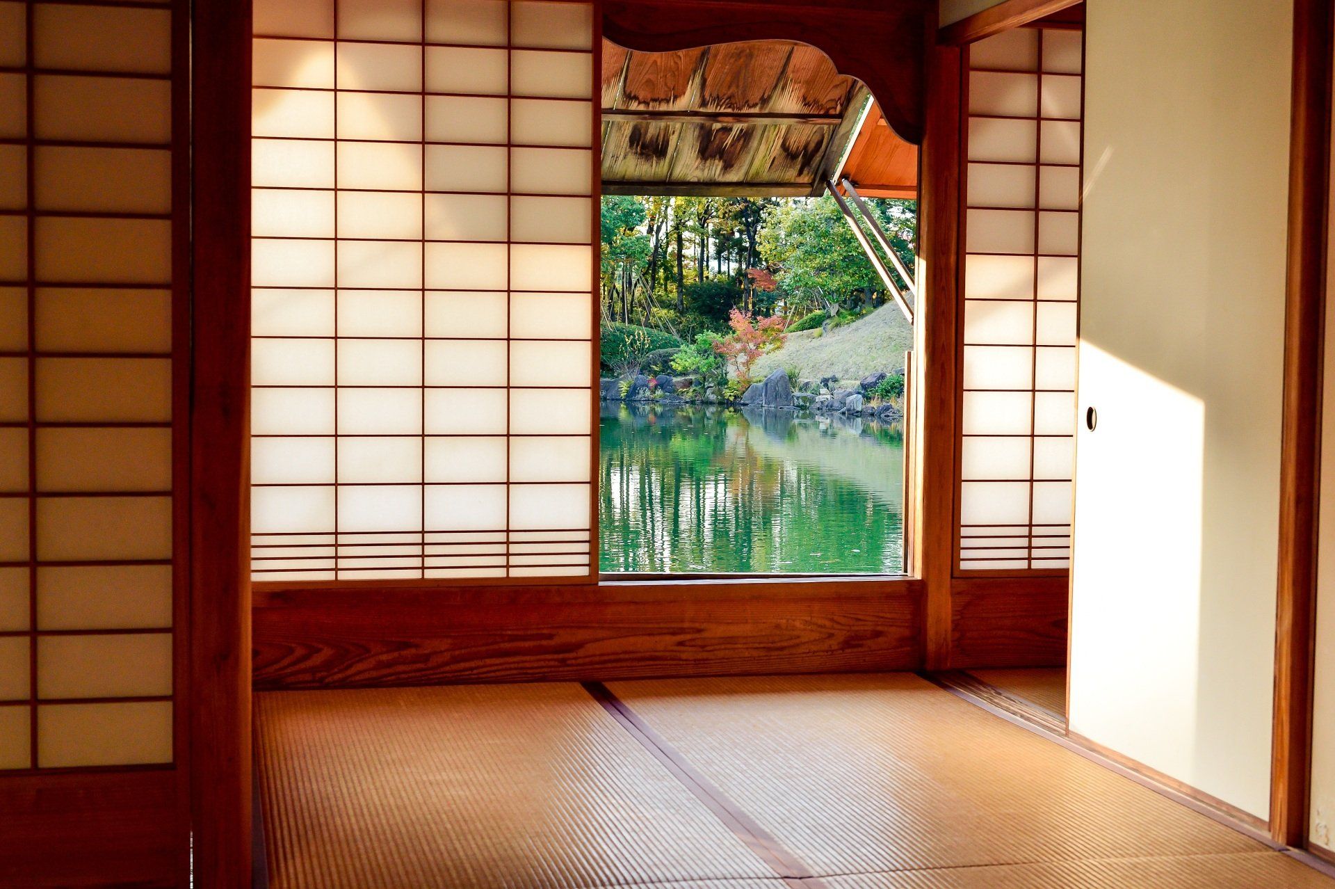 A room with a view of a lake through a window