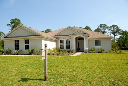 Single-story Florida home with a yard sign out front