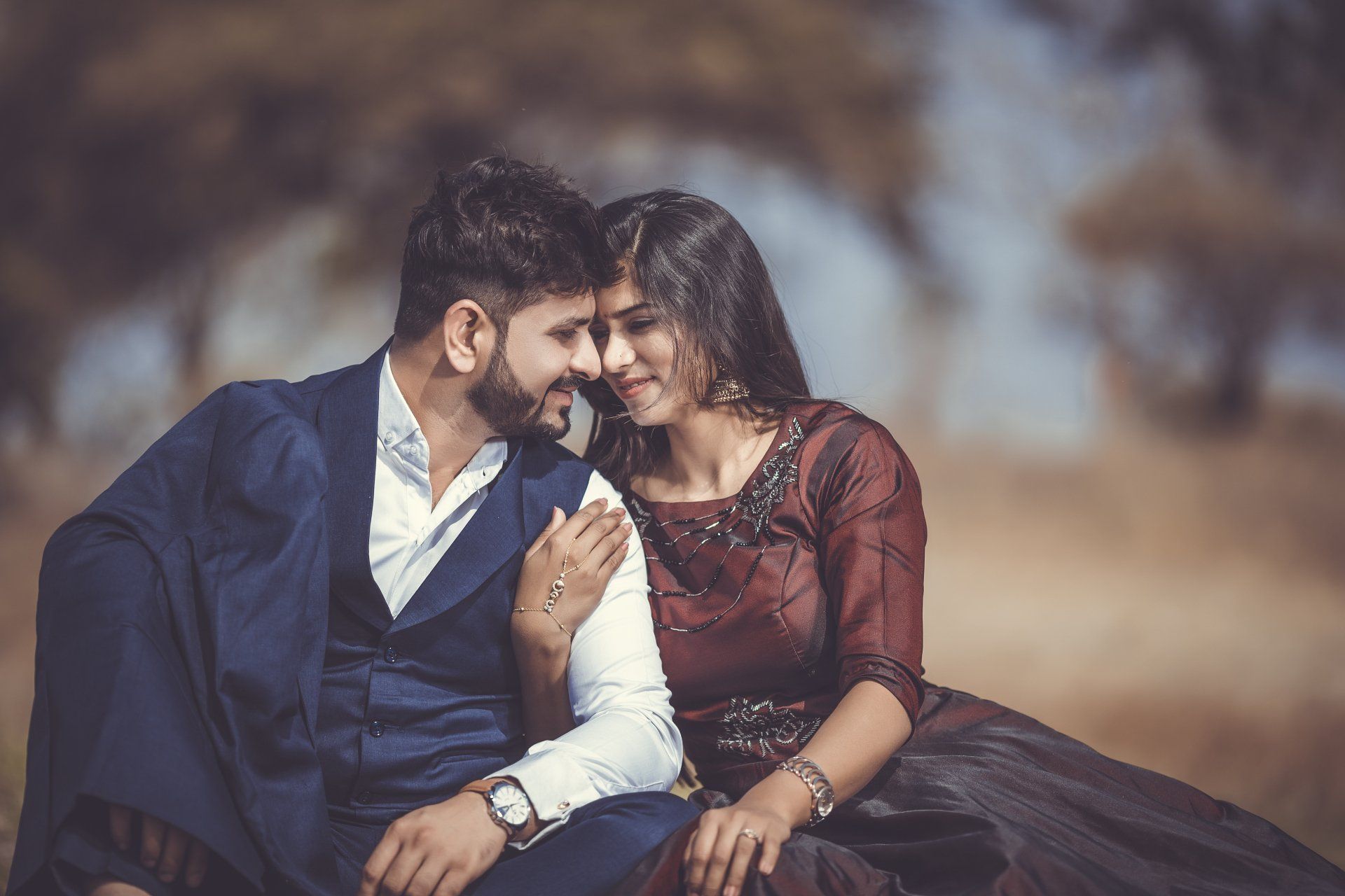 A man and a woman are sitting next to each other and looking at each other.