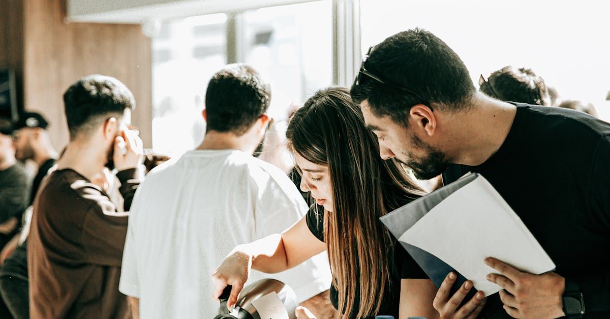 A group of people are standing around a table looking at papers.