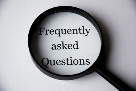 Magnifying glass over the words “Frequently asked Questions” 