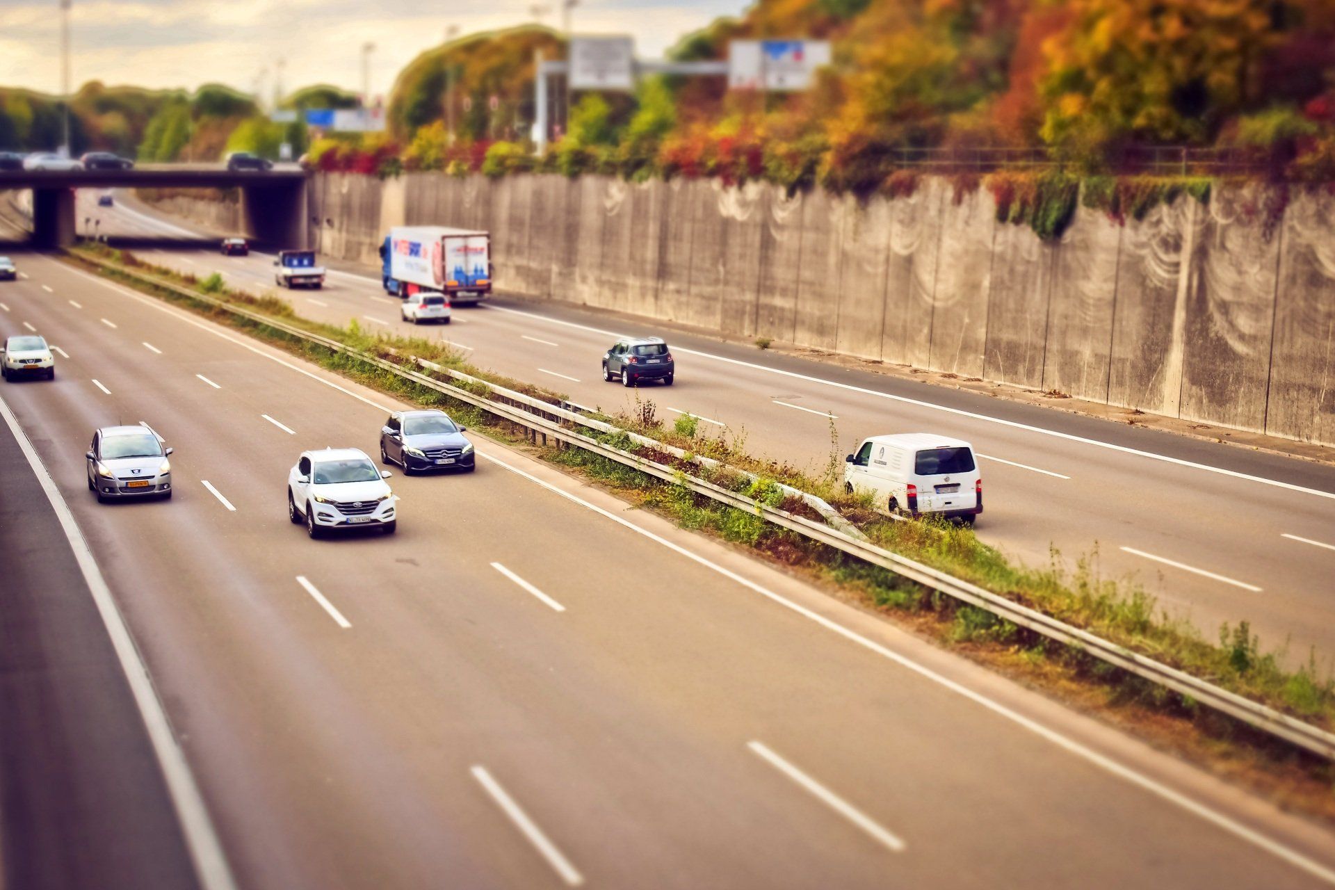 A highway with cars and trucks driving down it.