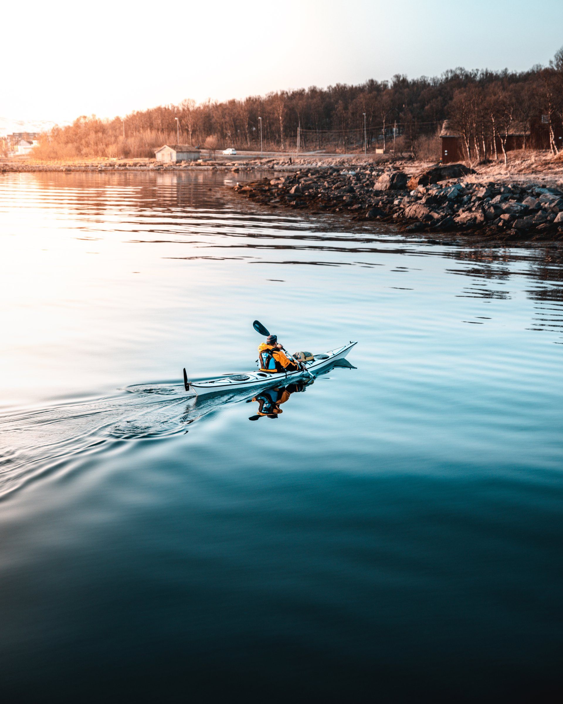 A person is paddling a kayak on a body of water.