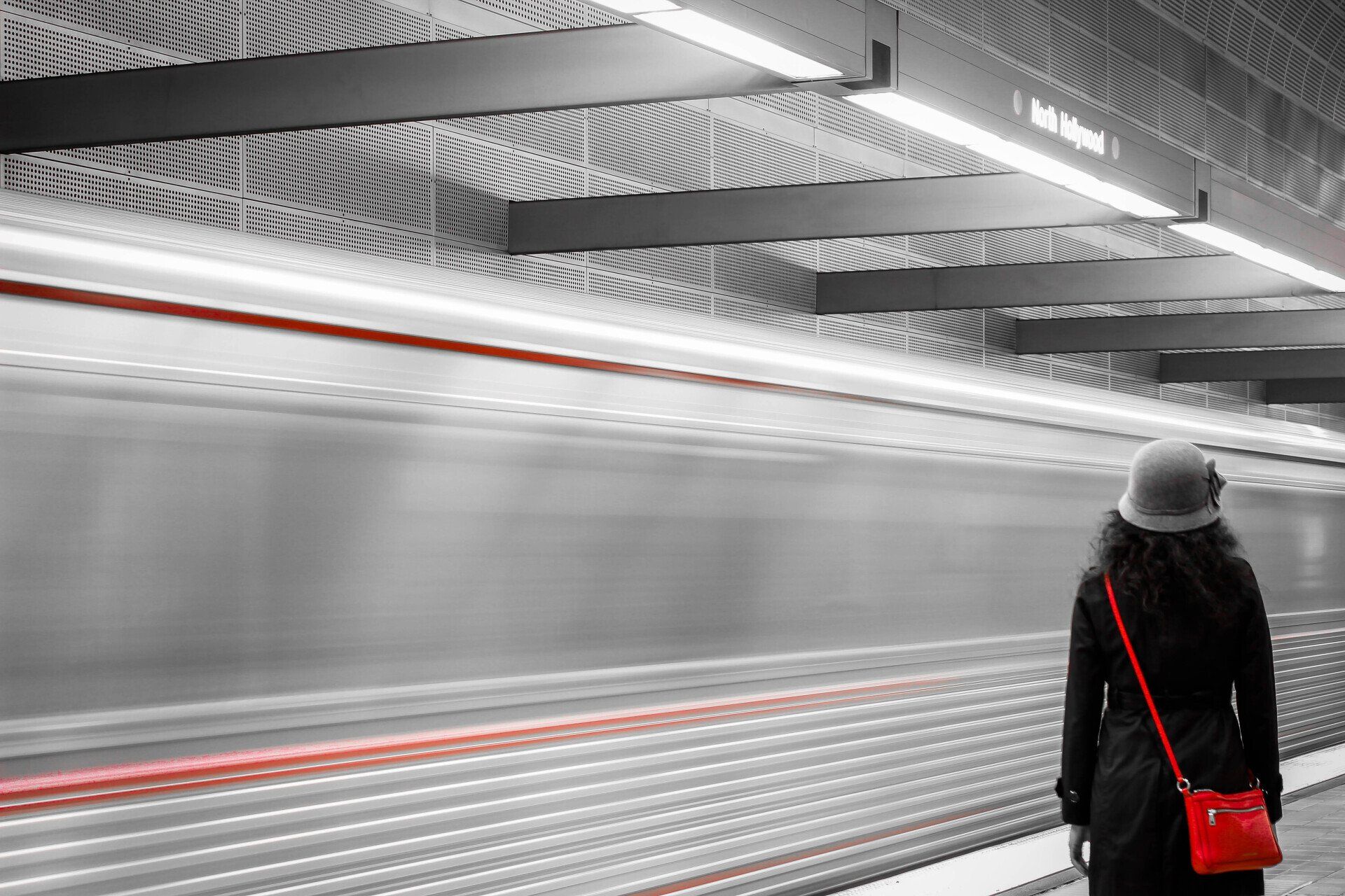 a woman waiting for a train at a subway station