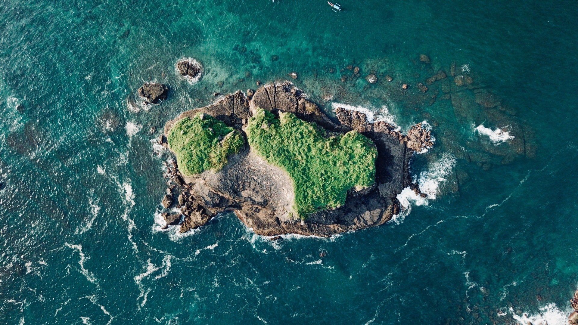 An aerial view of a small island in the middle of the ocean.