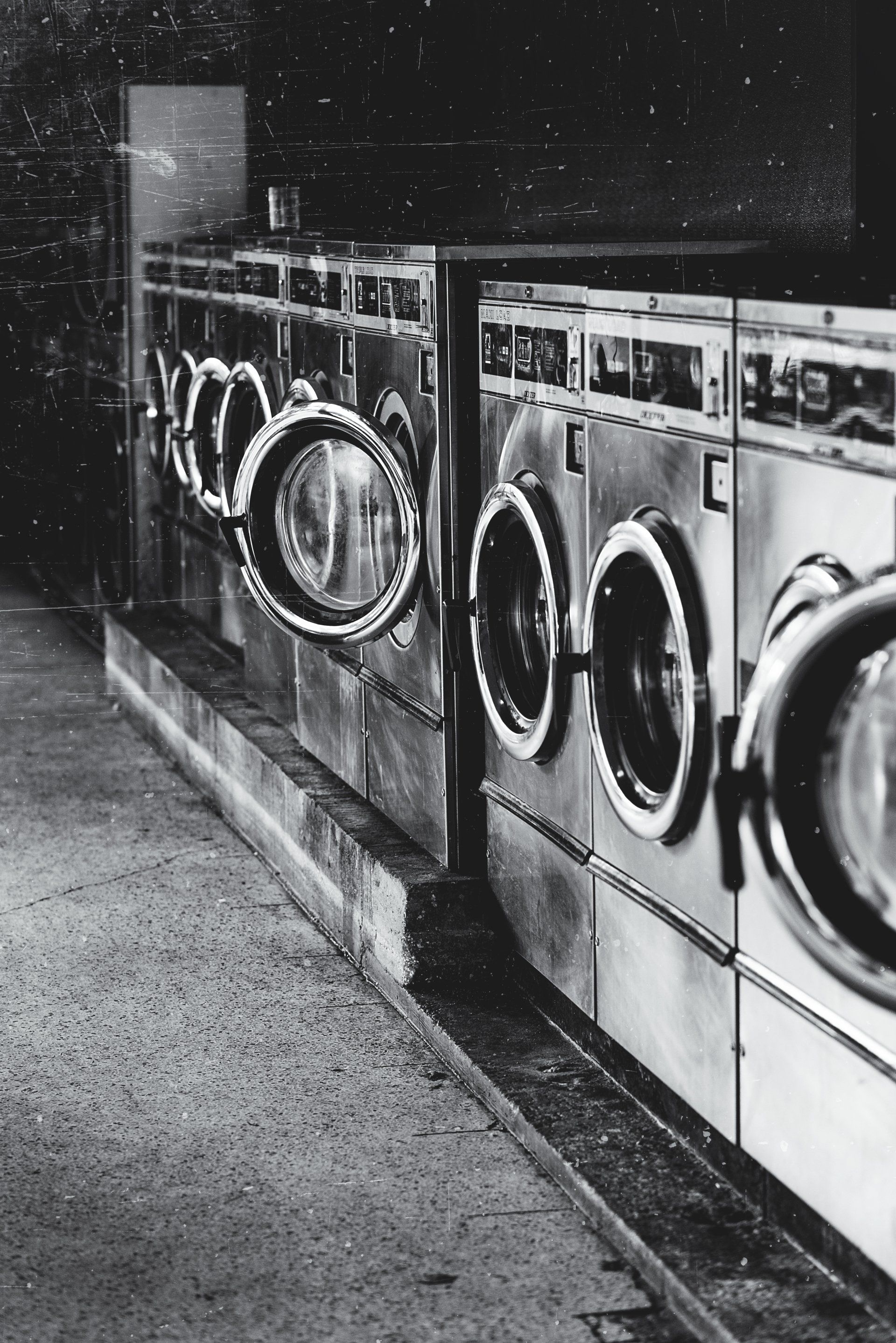 A black and white photo of a row of washing machines Prosworks installed