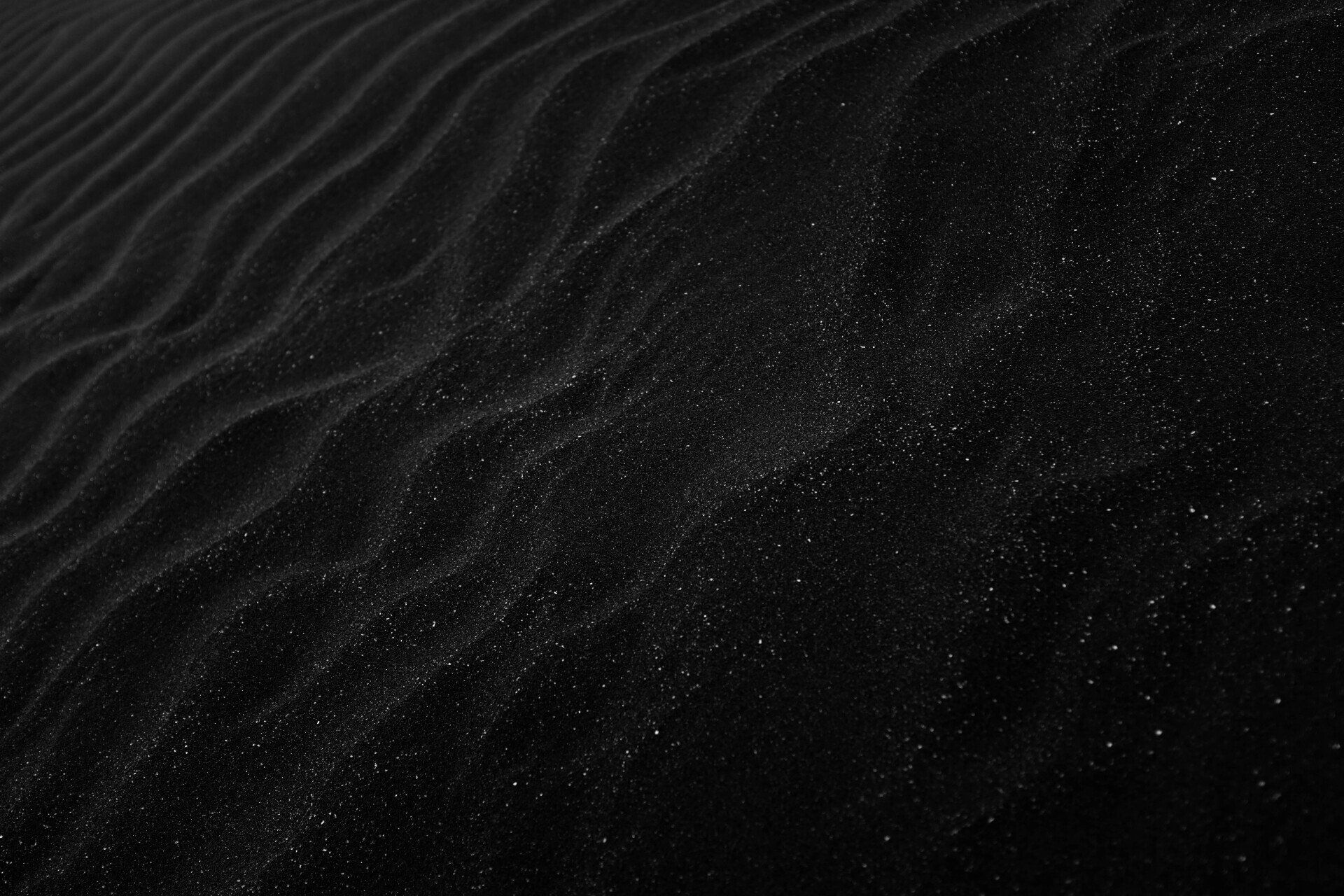 It is a black and white photo of a sand dune.