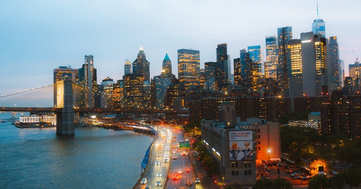 New York Skyline An aerial view of a city skyline at night with a bridge in the foreground.