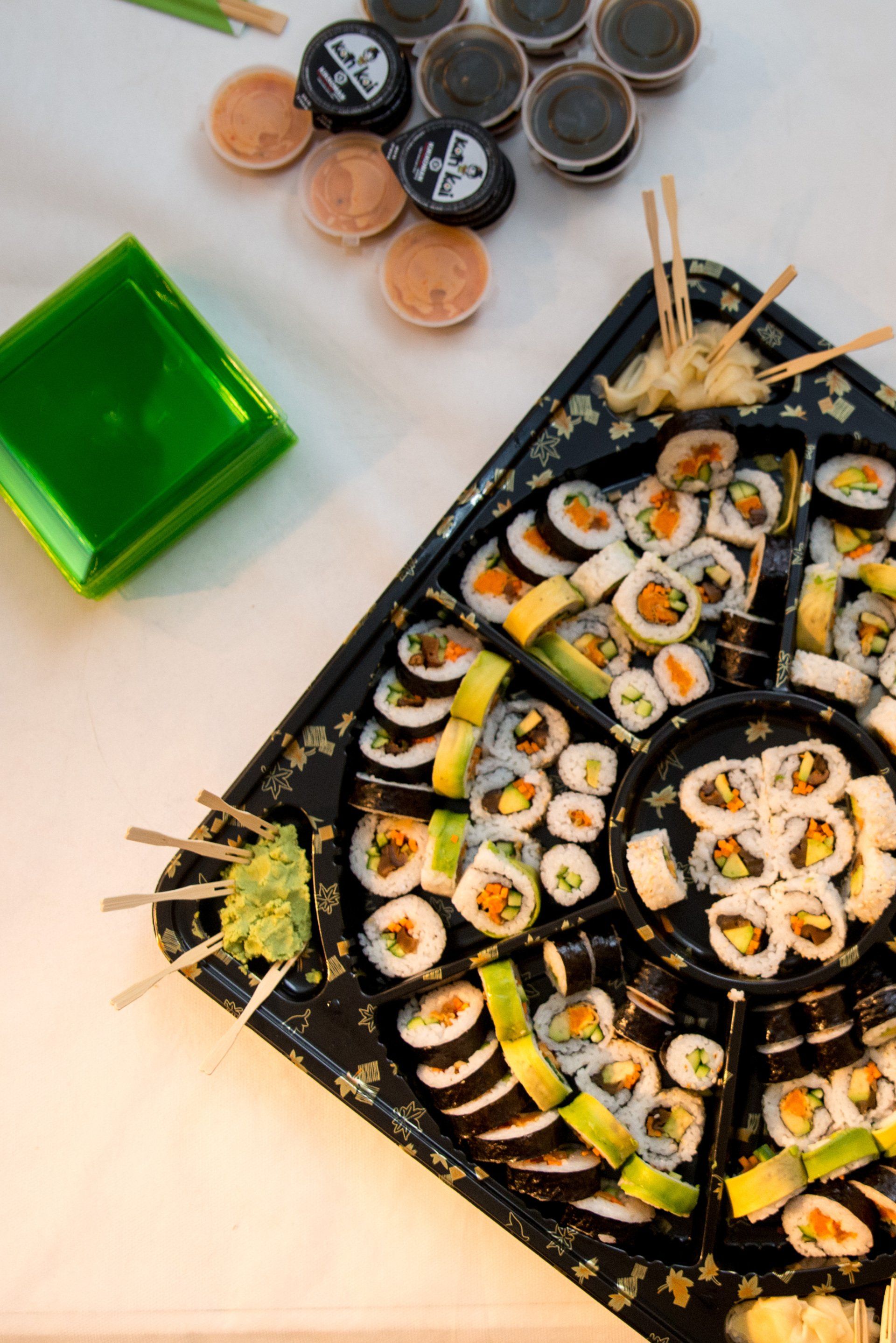 A tray of sushi and chopsticks on a table