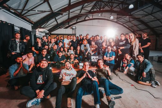 a large group of people are posing for a picture in a room .