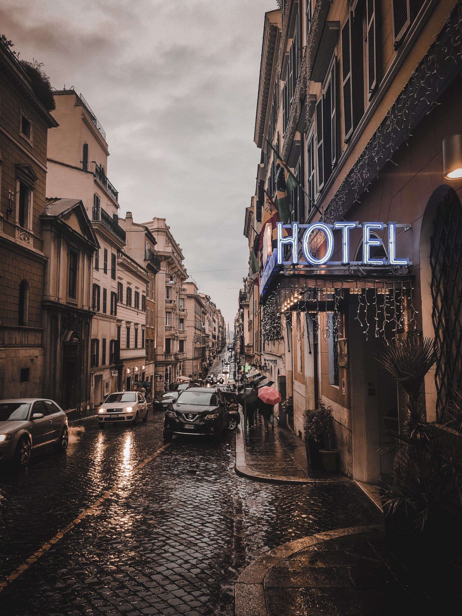 A city street with a hotel sign above it