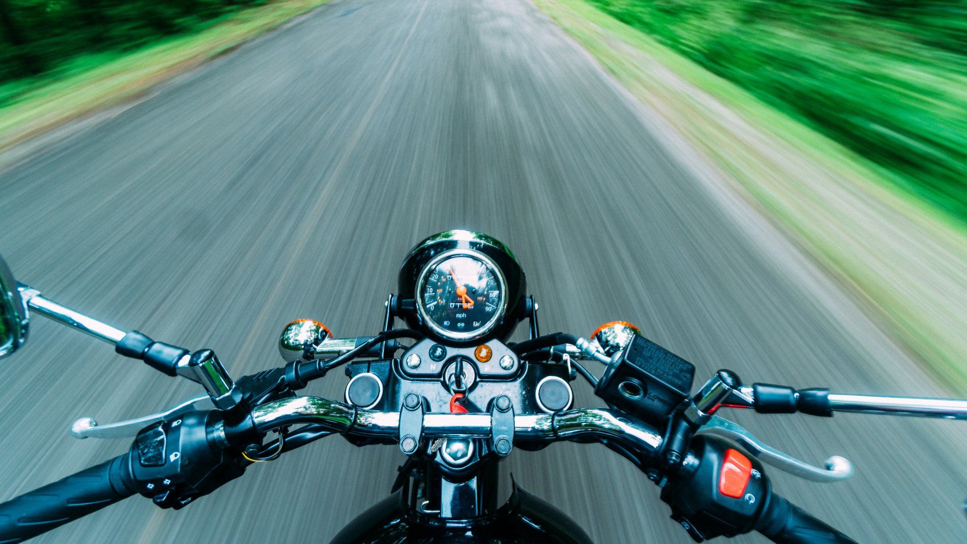 A person is riding a motorcycle down a road.