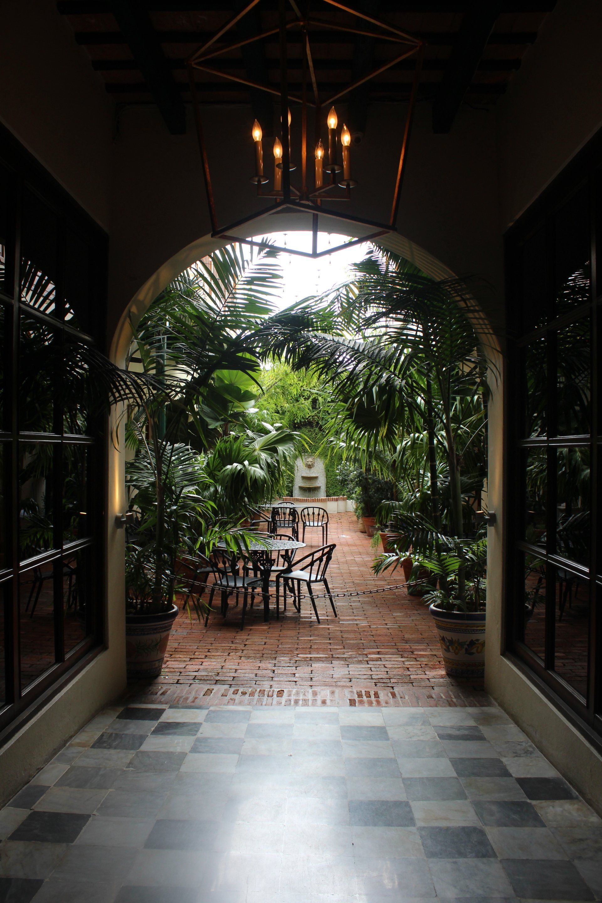 A Hallway Leading To A Garden With Tables And Chairs — Caprice Home Additions In Wingham, NSW