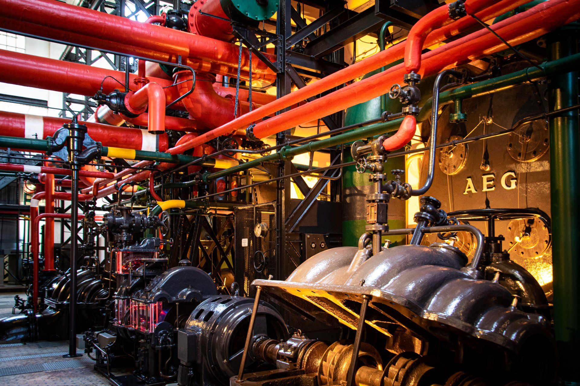A large room with lots of pipes and a sign that says aeg