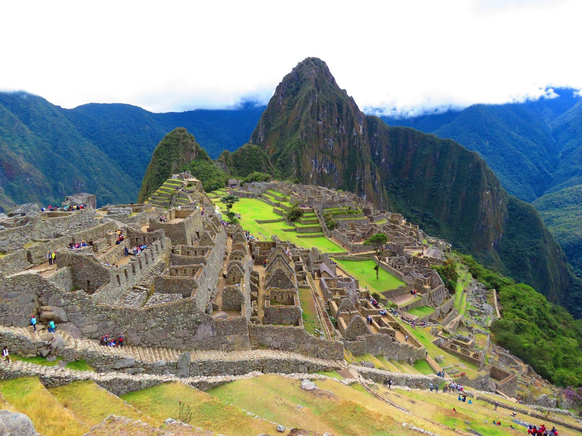 The ruins of the inca city of machu picchu are surrounded by mountains.